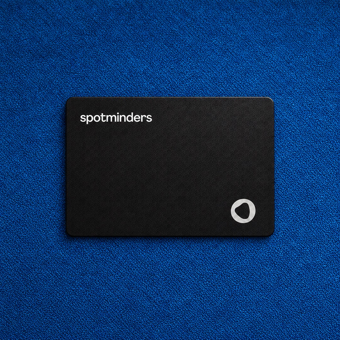 The black Spotminders tracking card lying flat on blue fabric