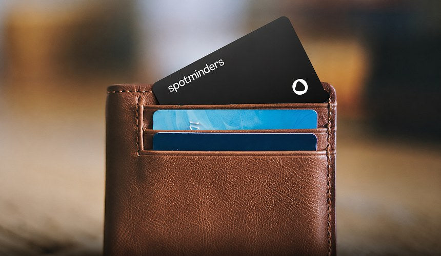 A Spotminders card in the card slot of a leather wallet